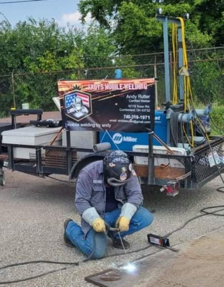 Andy welding on site beside his mobile welding rig
