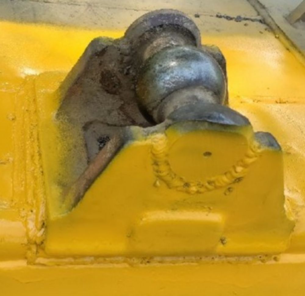 Repaired weld on a yellow dozer blade