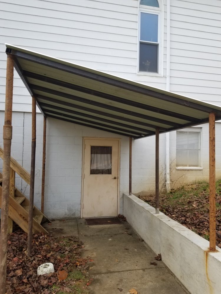 Steel lean-to roof built onto the side of a church